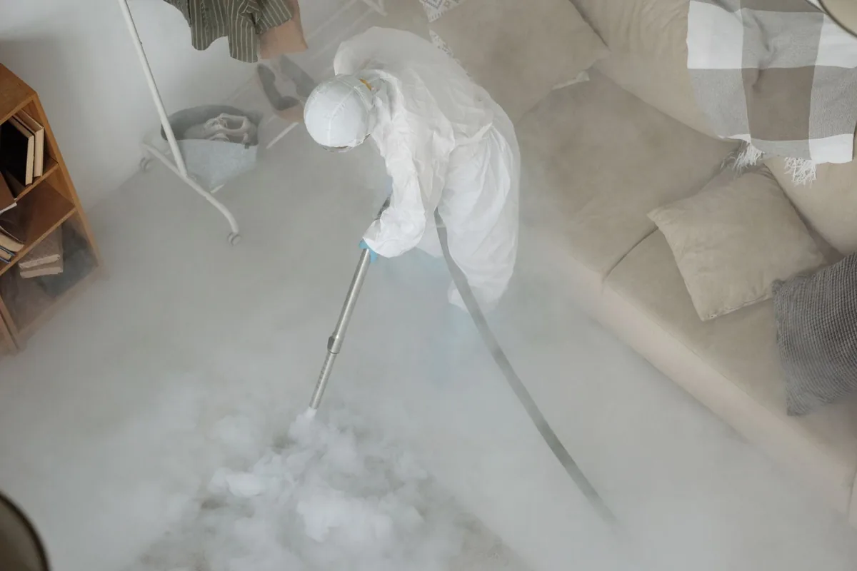 Biohazard cleanup technician in protective equipment, Peosta, IA
